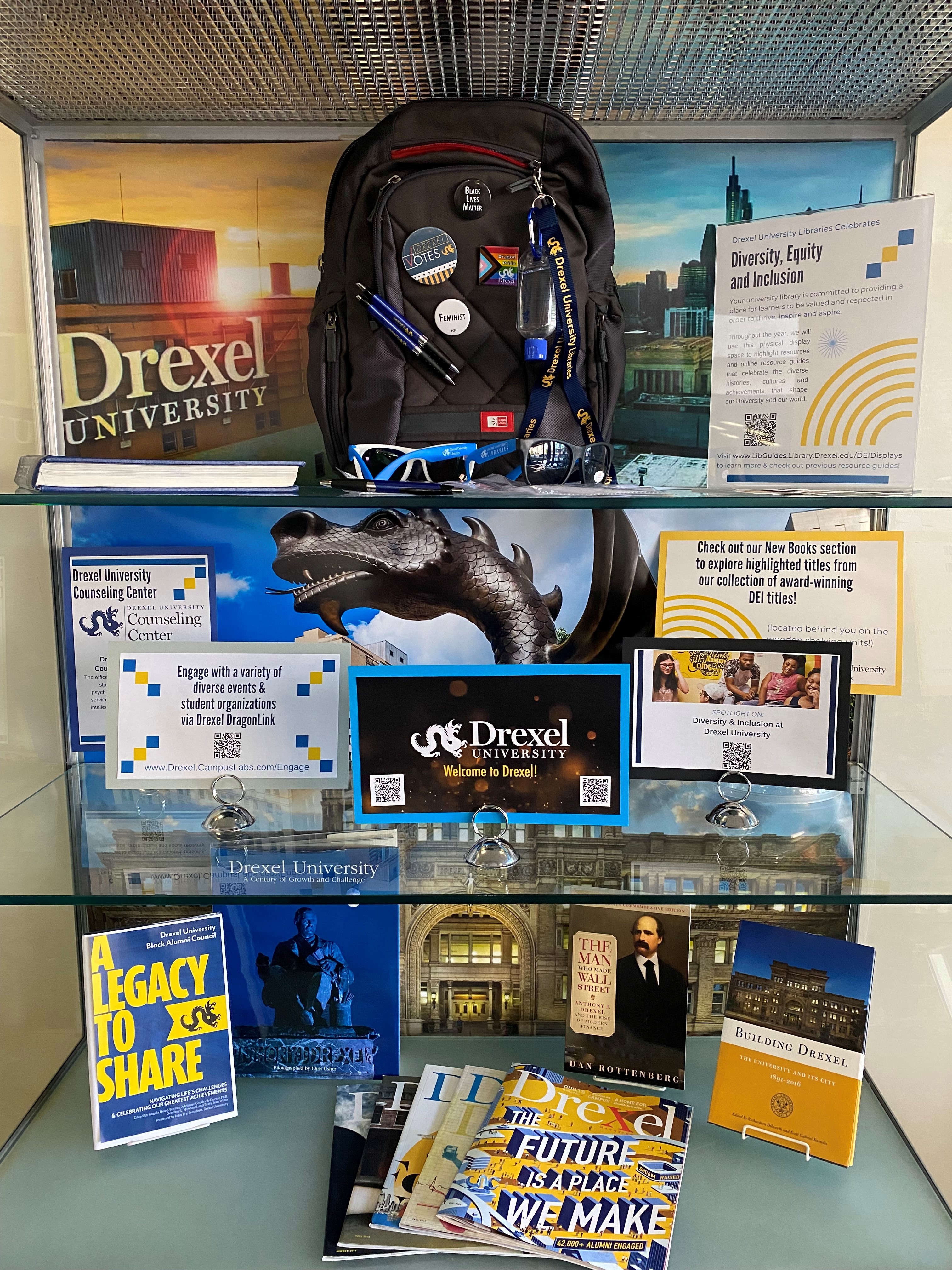 shelves with books and Drexel gear with signs that say welcome back